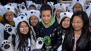 Li Bingbing (C, front), an ambassador of Earth Hour campaign in China, poses for a photo with volunteers dress in the polar bear costumes during an activity held by the World Wide Fund for Nature (WWF) to welcome the UN climate change conference in Copenhagen, in Beijing, capital of China, December 2, 2009.
