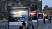 People look at pictures on display during a photo exhibition on climate change in Danish capital Copenhagen on December 6, 2009. The United Nations Climate Change Conference 2009 will open in Copenhagen on Monday.