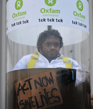 Oxfam activist stages underwater protest at climate talks.
