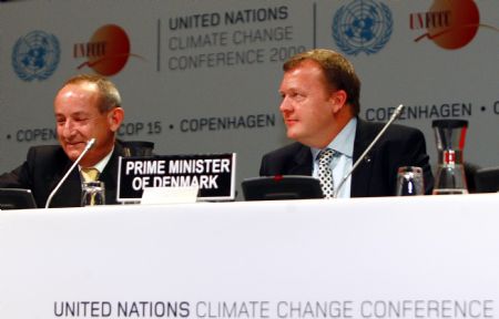 Danish Prime Minister Lars Lokke Rasmussen (R) and Yvo de Boer, executive secretary of the United Nations Framework Convention on Climate Change, attend the opening of the United Nations Climate Change Conference 2009, also known as COP15, at the Bella center in Copenhagen December 7, 2009.