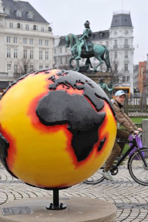 A man rides bike past the replica of a globe erected in central Copenhagen December 7, 2009.