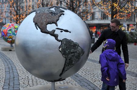 Local people view the replica of a globe erected in central Copenhagen December 7, 2009.