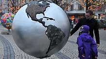 Local people view the replica of a globe erected in central Copenhagen December 7, 2009. The United Nations Climate Change Conference 2009, also known as COP15, kicked off at the Bella center in Copenhagen on Monday.