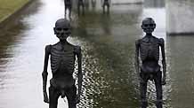The picture taken on December 8, 2009, shows models of supposed refugees come into being by climate change erected in water outside the conference center of the 3rd Annual Climate Change Summit in Copenhagen, Demark. UN's climate panel expects 200 million climate refugees before 2050.