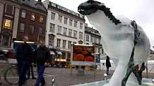 People pass by an ice sculpture of a polar bear as it melts to reveal a bronze skeleton in Copenhagen December 8, 2009.