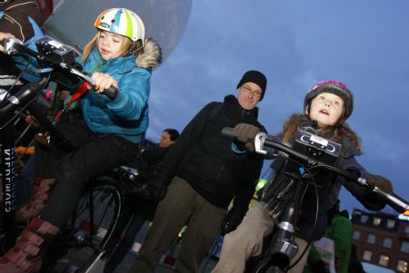 Two girls ride a bicycle to light a Christmas tree in Copenhagen, Denmark, on December 8, 2009.