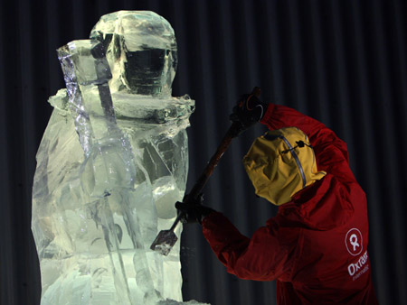 An ice carver makes a statue of Maasai warrior outside the UN Conference Centre in Denmark's capital Copenhagen as the first week of negotiations comes to a close, December 10, 2009.