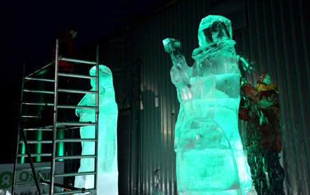 An ice carver makes statues of Maasai warriors outside the UN Conference Centre in Denmark's capital Copenhagen as the first week of negotiations comes to a close, December 10, 2009.