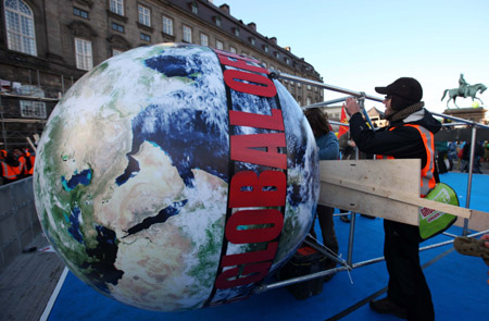 Environmentalists install a large globe balloon to attend the Global Day of Action at parliament square in Copenhagen, capital of Denmark, on December 12, 2009.