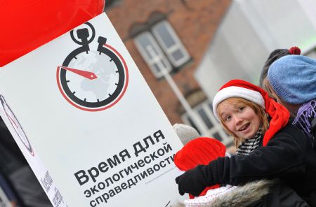 People look at boards promoting the Time For Climate Justice campaign in Copenhagen, Denmark, December 13, 2009. 