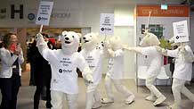 Environmentalists wearing polar bear costumes hold placards at the Bella center of Copenhagen, capital of Denmark, December 14, 2009, during the UN Climate Change Conference.