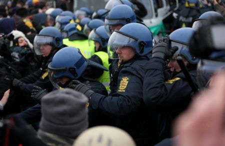 Policemen disperse protesters outside Bella center in Copenhagen, Denmark, December 16, 2009. 