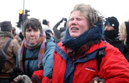 A woman suffers the tear gas outside Bella center in Copenhagen, Denmark, December 16, 2009.