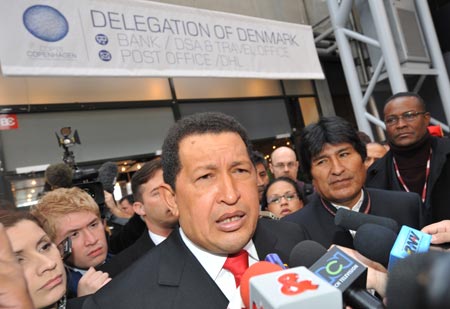 Bolivian President Evo Morares (R) and Venezuelan President Hugo Chavez are surrounded by journalists when leaving the plenary room to protest the delayed opening of the leaders' meeting due to the absence of main developed countries during the UN climate change conference in Copenhagen, Denmark, December 18, 2009.
