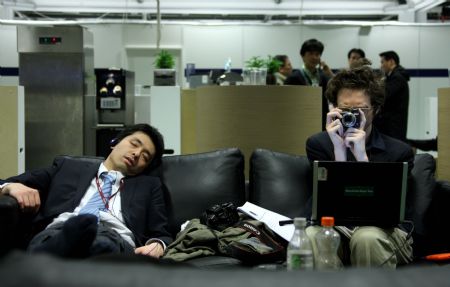 People rest on the couches at the Bella Center during the United Nations Climate Change Conference in Copenhagen, capital of Denmark, Dec. 19, 2009. (Xinhua/Xie Xiudong)