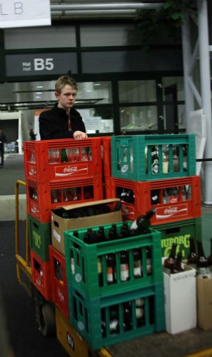 Cleaners move away used bottles from the Bella Center during the United Nations Climate Change Conference in Copenhagen, capital of Denmark, Dec. 19, 2009. (Xinhua/Xie Xiudong)