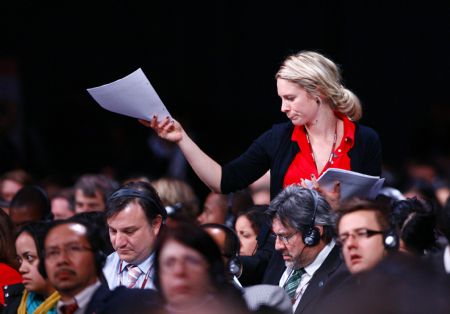 A staff member distributes a draft accord during a night plenary session at the United Nations Climate Change Conference in Copenhagen, capital of Denmark, December 19, 2009. 