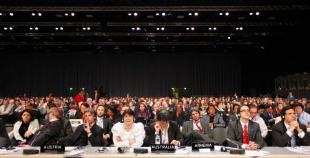 Delegates attend a night plenary session at the United Nations Climate Change Conference in Copenhagen, capital of Denmark, December 19, 2009.