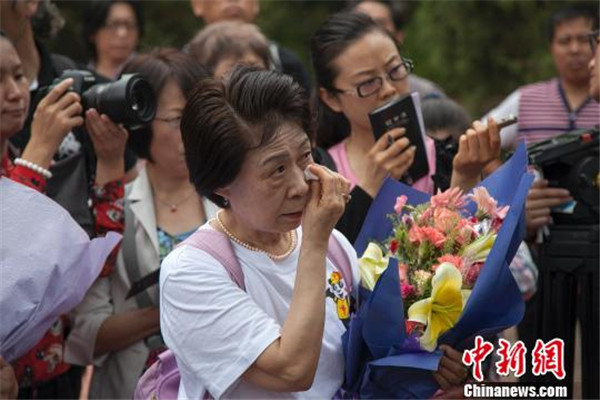 Ikeda Sumie, director general of a Tokyo support group for those Japanese orphans returned from China, mourns for adoptive parents in front of a grave in a cemetery to memorize adoptive Chinese parents in Fangzheng county in Northeast China's Heilongjiang province, July 13, 2015. [Photo/Chinanews.com]