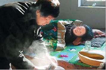 Meng helps care for his paralyzed mother at home in Gucheng county, Hebei province. 