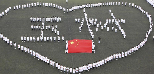 Tianjin: Students from Tianjin Medical University stand in a heart shape while praying for the quake victims in Yushu prefecture of China’s Northwest Qinghai province on April 21, 2010. 