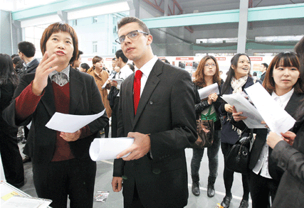 Andres Acosta Egea, 24, attends a job fair at the Shanghai University of Finance and Economics yesterday. A local university student, Egea said the employment situation in his own country, Spain, was not very good.