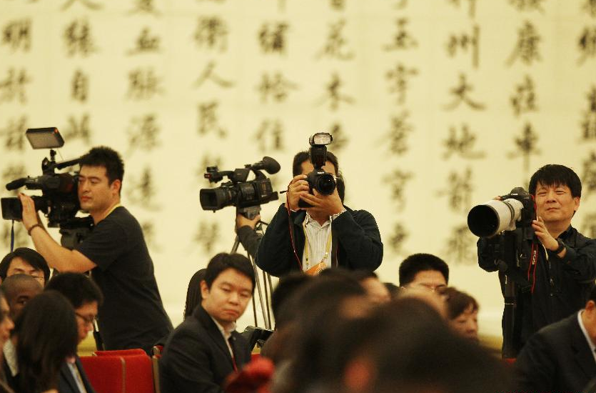 Photographers and cameramen are seen working at the first press conference of the 18th National Congress of the Communist Party of China (CPC) at the Great Hall of the People in Beijing, capital of China, Nov. 7, 2012. The 18th CPC National Congress will be opened in Beijing on Thursday. [Photo/Xinhua]