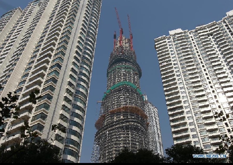 Photo taken on Dec. 8, 2012 shows the Shanghai Tower (C), a skyscraper under construction, in Pudong, east China's Shanghai Municipality. The Shanghai Tower is expected to reach 632 meters in height and start service in 2015.[Photo/Xinhua]