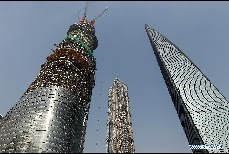 Photo taken on Dec. 8, 2012 shows the Shanghai Tower (L), a skyscraper under construction, along with the neighbouring Jin Mao Tower (C) and the Shanghai World Financial Center in Pudong, east China's Shanghai Municipality. The Shanghai Tower is expected to reach 632 meters in height and start service in 2015.