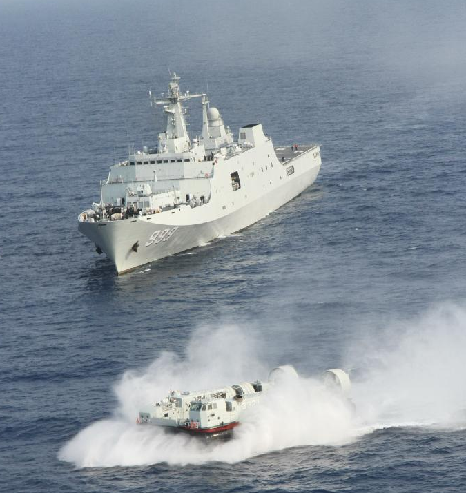 The warship Jinggangshan is seen during a coordination training with a hovercraft in waters near south China's Hainan Province, March 20, 2013.[Photo/Xinhua]