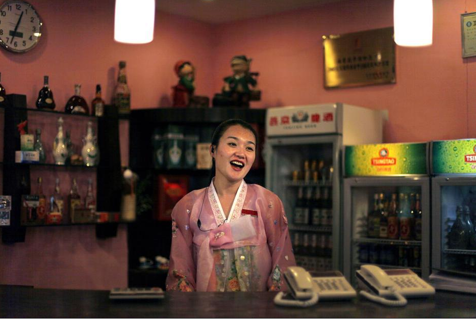 A beautiful North Korean waitress works at a restaurant near the North Korean Embassy in Beijing, on March 16, 2009.,