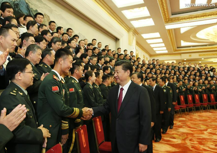 Chinese President Xi Jinping (front) meets with the officials of the organizing group as well as representatives of the troops and artists that took part in the activities held to mark the 70th anniversary of the victory of Chinese People's War of Resistance against Japanese Aggression and the World Anti-Fascist War, in Beijing, capital of China, Sept. 16, 2015. (Xinhua/Lan Hongguang)