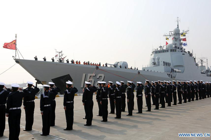 Sailors solute on board of destroyer Jinan as they return to a military port in Zhoushan, east China's Zhejiang Province, Feb. 5, 2016. 