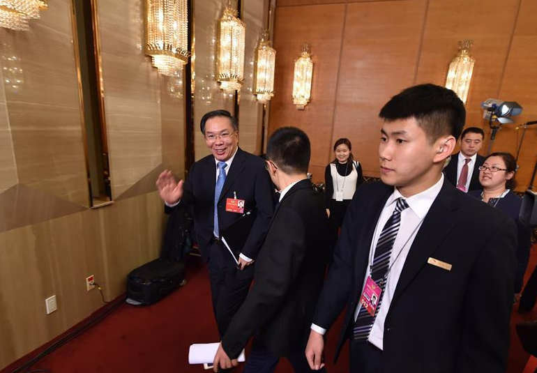 Wang Guoqing (1st L), spokesperson for the Fourth Session of the 12th Chinese People's Political Consultative Conference (CPPCC) National Committee, leaves after a press conference at the Great Hall of the People in Beijing, capital of China, March 2, 2016. (Xinhua/Li Xin)