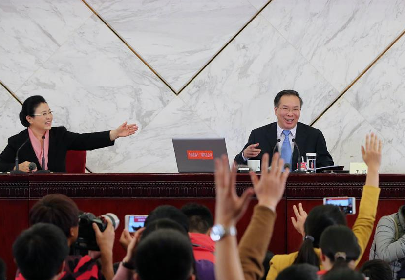 Journalists raise hands to ask questions during a press conference of the Fourth Session of the 12th Chinese People's Political Consultative Conference (CPPCC) National Committee at the Great Hall of the People in Beijing, capital of China, March 2, 2016. (Xinhua/Yin Gang)