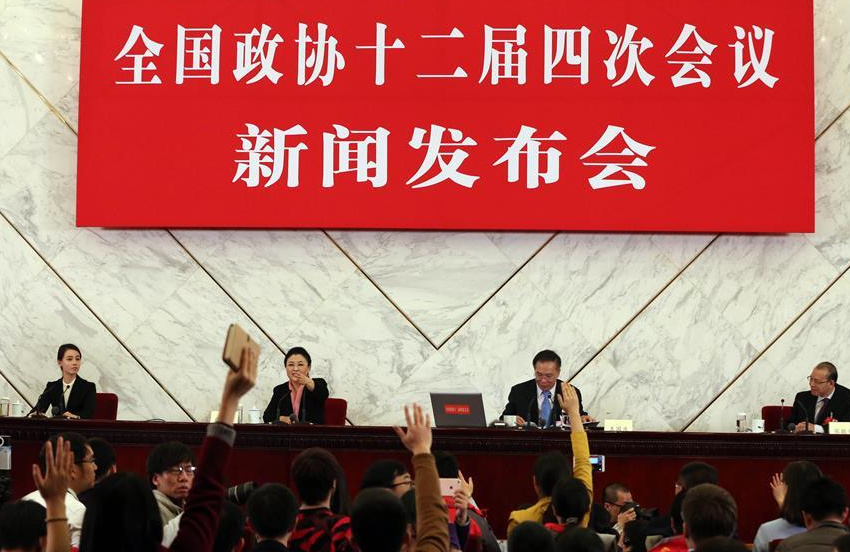 Journalists raise hands to ask questions during a press conference of the Fourth Session of the 12th Chinese People's Political Consultative Conference (CPPCC) National Committee at the Great Hall of the People in Beijing, capital of China, March 2, 2016. (Xinhua/Yin Gang) 