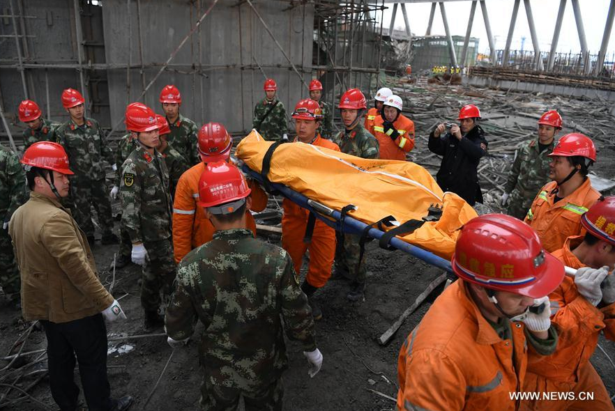Rescuers work at the accident site at the Fengcheng power plant in east China's Jiangxi Province, Nov. 24, 2016. Seventy-four people have been confirmed dead after the platform of the Fengcheng power plant's cooling tower under construction collapsed on Thursday. (Xinhua/Wang Xiang)