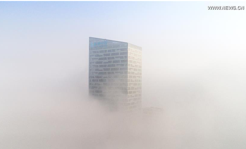 Photo taken on Jan. 3, 2017 shows a fog-bound building in Hefei, capital of east China's Anhui Province. A red alert for fog in large parts of China was issued by the National Meteorological Center on Tuesday. (Xinhua/Guo Chen)