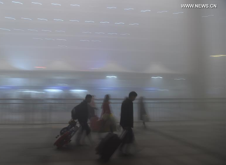 Passengers walk at the Hefei Railway Station in fog-bound Hefei, capital of east China's Anhui Province, Jan. 3, 2017. A red alert for fog in large parts of China was issued by the National Meteorological Center on Tuesday. (Xinhua/Yang Xiaoyuan) 
