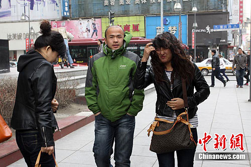 在长春市,路上行人都以纱巾,口罩等物品掩面以防风中的沙尘进入眼睛