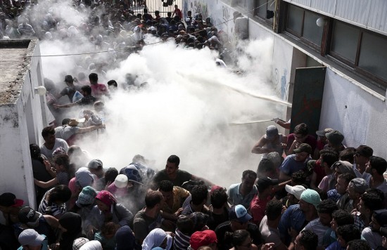 希腊警方为非法移民 搬家 朝人群喷洒 灭火剂 防