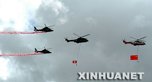 7月1日，香港金紫荆广场举行升旗仪式，庆祝香港回归祖国十周年。这是直升机携带国旗和区旗飞过维多利亚港上空。