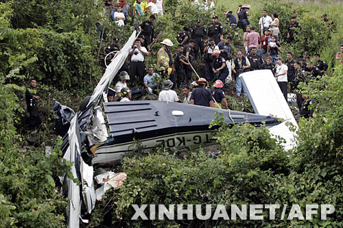 8月12日，人們在危地馬拉首都危地馬拉城以北約14公里處的飛機(jī)墜毀現(xiàn)場附近圍觀。當(dāng)日，一架輕型飛機(jī)準(zhǔn)備在危地馬拉城的拉奧羅拉國際機(jī)場著陸時(shí)墜毀，造成機(jī)上包括3名兒童在內(nèi)的6人喪生。