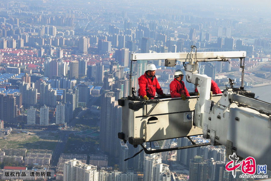 2013年4月2日，在上海环球经贸大厦492米高度进行空中作业的清洁工。中国网图片库 贺友保摄