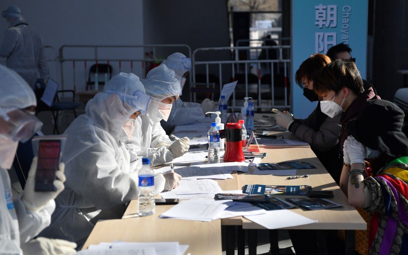 3月17日，北京新国展入境人员集散点，入境人员填写个人信息。摄影/新京报记者 李木易
