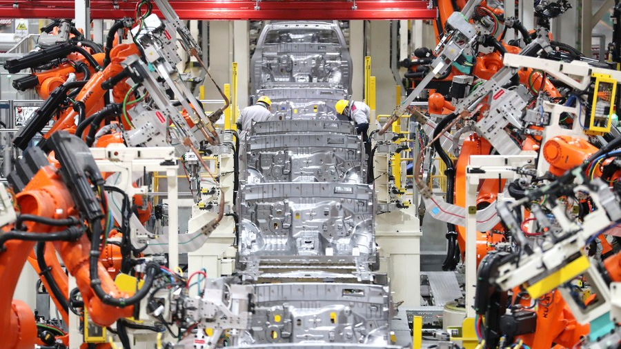 Robots conduct welding work at the workshop of an automobile manufacturing factory in Qingdao, east China's Shandong Province, January 14, 2023. /Xinhua