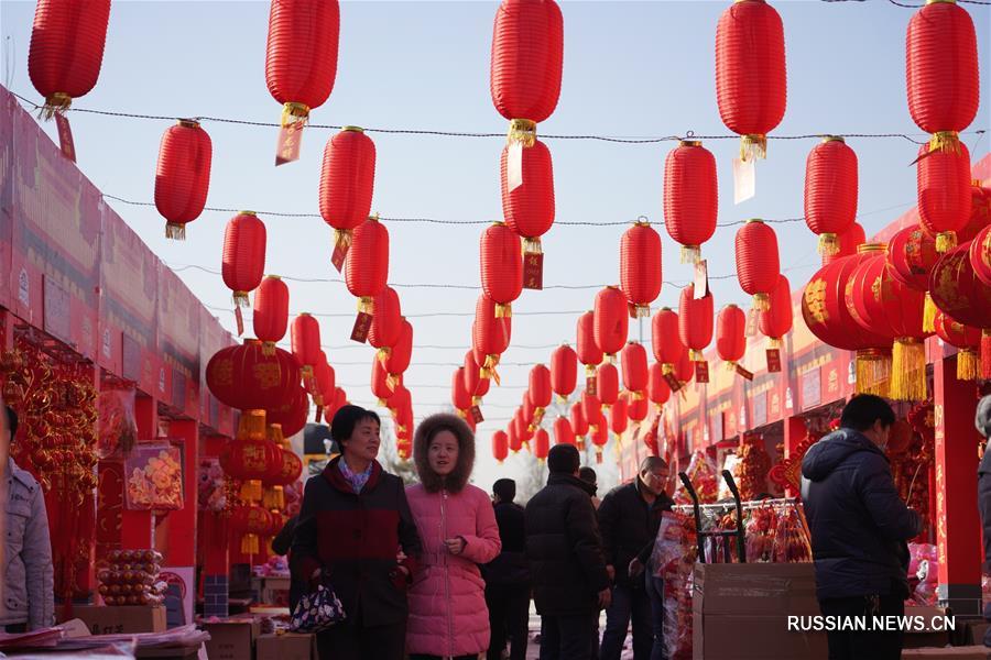 На фото -- новогодний рынок в поселке Чжэндин одноименного уезда провинции Хэбэй /Северный Китай/. 
