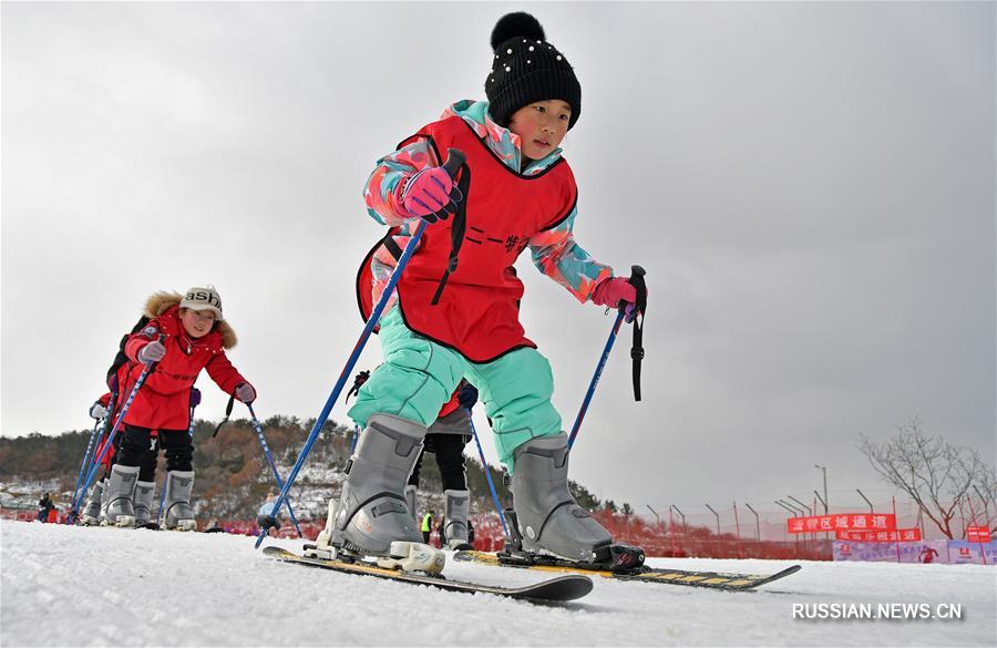 На снимке, сделанном 12 января этого года, дети катаются на лыжах на одной из горнолыжных баз в г. Яньтай пров. Шаньдун /Восточный Китай/.