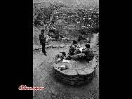  Students study on a stone grinder in a village in Shaanxi province.