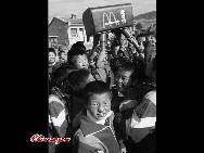 Students receive sports facilities donated by the McDonald's Corporation in Xifeng, Gansu province. 